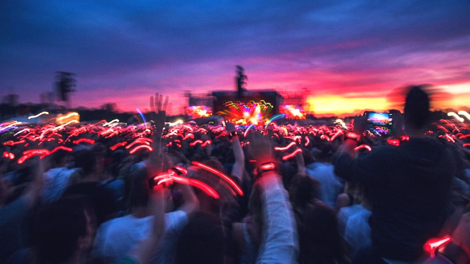 Crowd at night, wrists lit